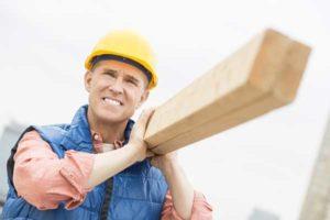Construction Worker Carrying Wood Planks — Waukegan, IL — Daniels, Long & Pinsel, LLC