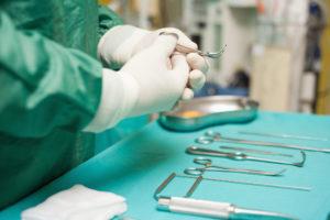 Surgeon Choosing a Surgical Instrument — Waukegan, IL — Daniels, Long & Pinsel, LLC